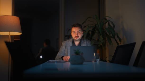 istock Businessman working alone in office at night 1482570519