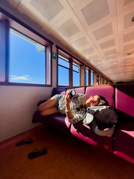 istock Woman lying on side, looking at mobile phone 1482573912