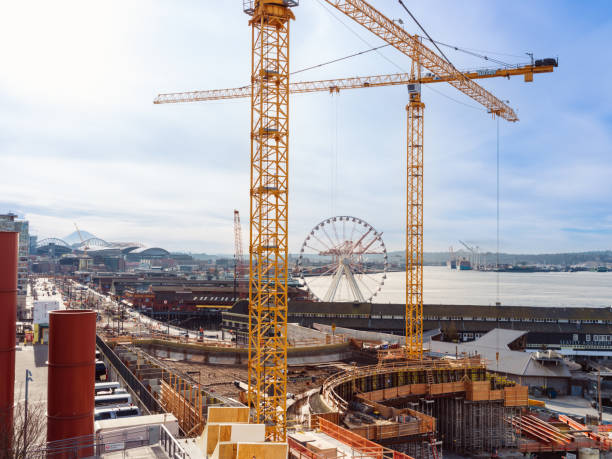 View of the Seattle Ferris Wheel at Pier 57 Busy construction view from elevated viewpoint of Seattle Ferris Wheel at Pier 57 seattle ferris wheel stock pictures, royalty-free photos & images