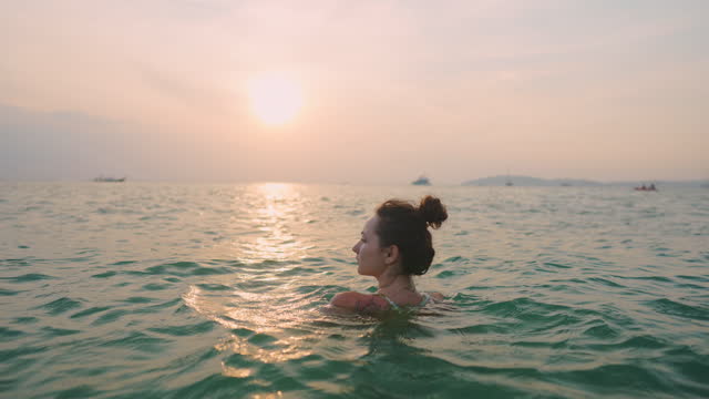 Qoman swimming at sunset