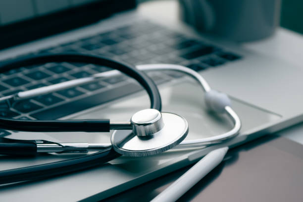 istock A stethoscope is placed on a laptop and a tablet computer. working on a computer at a clinic table in the background. 1482583376