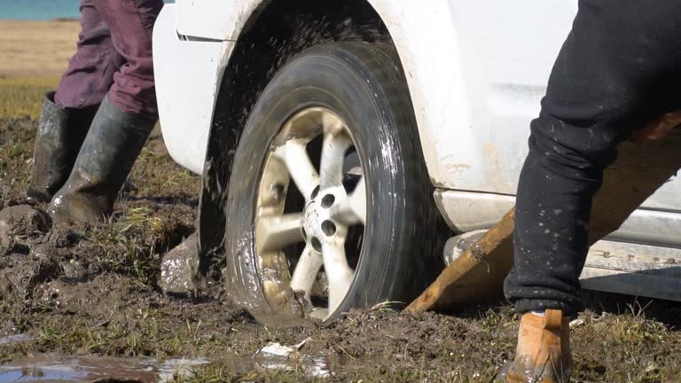 Slow motion view of stuck car in mud