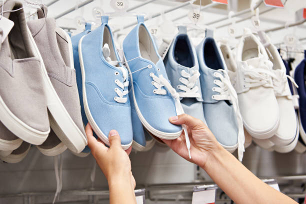 Buying shoes in store stock photo