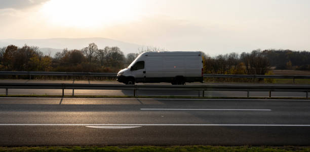istock White delivery van on the highway. White modern delivery small shipment cargo courier van moving fast on motorway road to city urban suburb. The business distribution and logistics express service. 1482583737