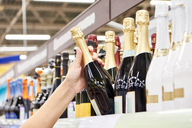 istock Bottle of champagne on hands in store 1482583740