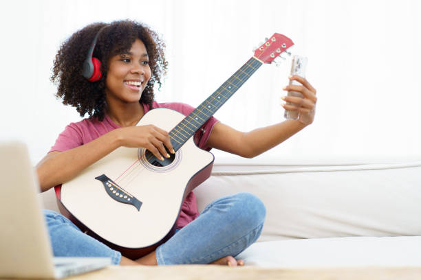 istock Woman enjoy playing a guitar and singing. 1482584527