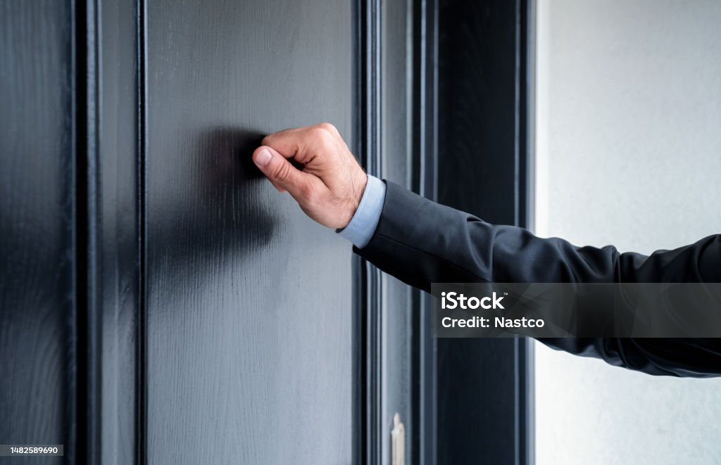 Someone's Knocking At The Door Somebody's Ringing The Bell Close Up Of Young Man Knocking On The Door Stock Photo - Download Image