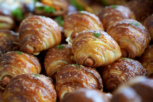 istock Freshly baked sausage croissant is displayed in a bakery store 1482591173
