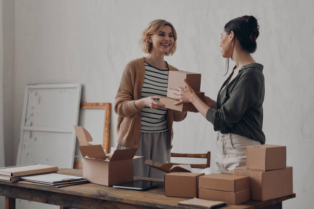istock Two confident women working together while preparing packages for delivery in warehouse 1482591477