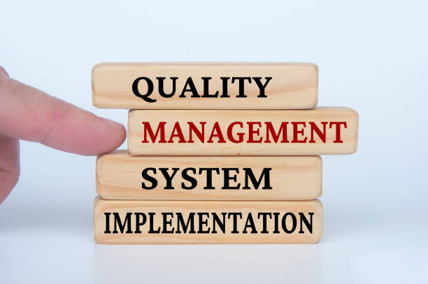 istock Quality Management System Implementation text on wooden blocks. Business culture and Operational excellence concept 1482592951