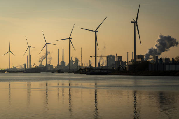 steel industry and wind turbines along the north sea canal at ijmuiden, the netherlands - ijmuiden imagens e fotografias de stock