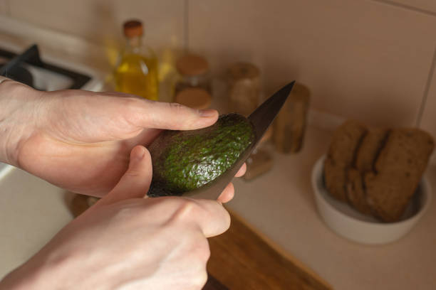 istock Young man preparing toast with avocado and egg for breakfast in the kitchen 1482599218