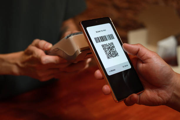 istock Cropped image man paying with smart phone in a cafe, contactless payment with QR code 1482599365