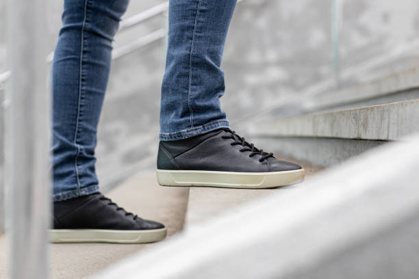 istock man climbs the stone steps on the street 1482602306