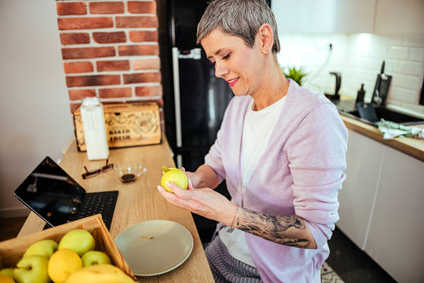 istock Woman peels an apple 1482604507