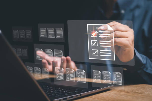 istock Document management and checklist concept, Businessman checks a digital checklist and use a laptop manage documents online in a storage system with paperless operation 1482605205