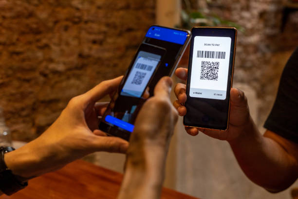 istock Cropped image man paying with smart phone in a cafe, contactless payment with QR code 1482606855
