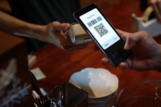istock Cropped image man paying with smart phone in a cafe, contactless payment with QR code 1482607057
