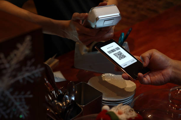 istock Cropped image man paying with smart phone in a cafe, contactless payment with QR code 1482608505