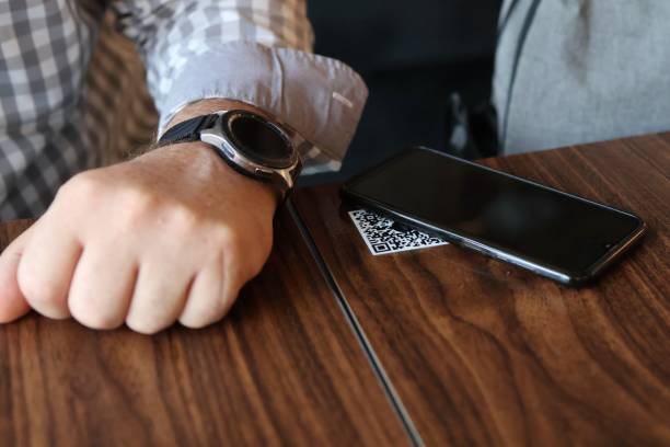 istock A traveler uses his cell phone at a restaurant to read the menu and order by QR code 1482609183