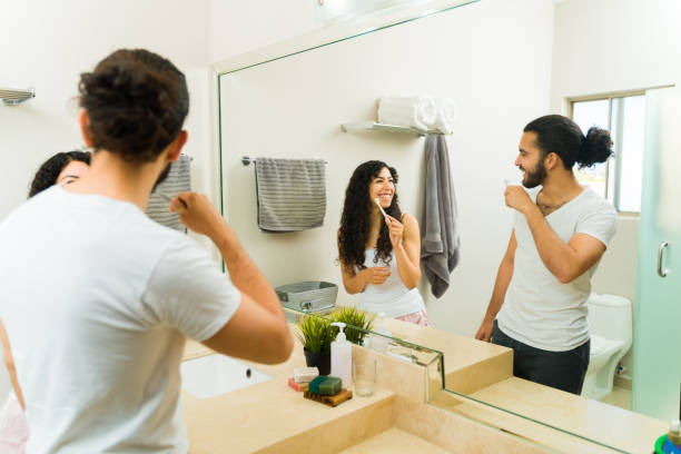 istock Cheerful boyfriend and girlfriend brushing their teeth 1482611862