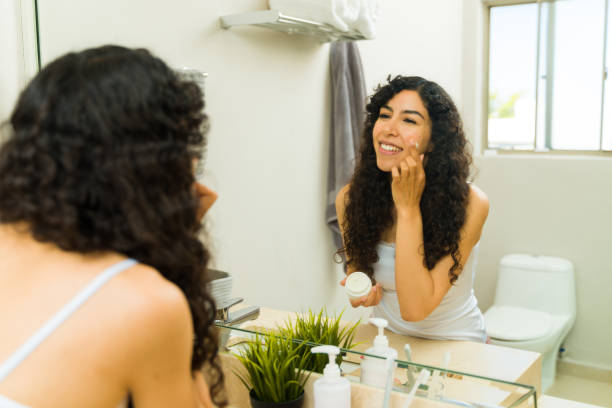 istock Happy young woman doing her skin care routine 1482611945