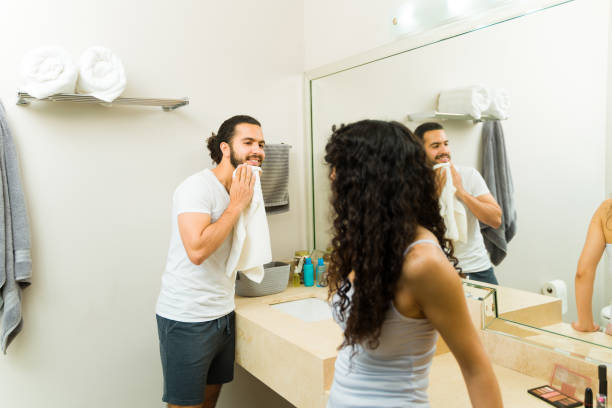 istock Young man grooming his beard in the bathroom talking with his girlfriend 1482612009