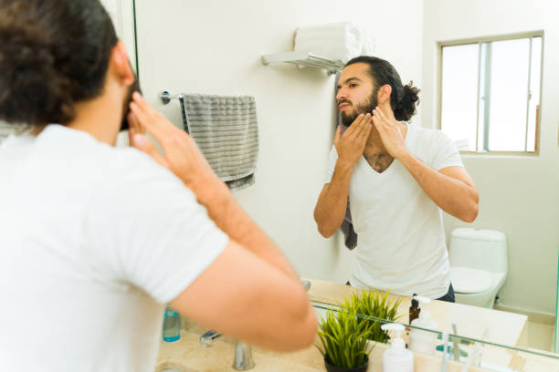 istock Latin young man cleaning and washing his beard 1482612046