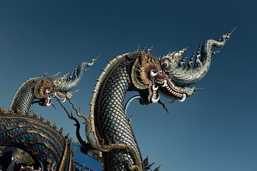 The Naka (Thai Folklore Dragon) statues at Wat Rong Suea Ten Blue Temple in Chiang Rai, Thailand