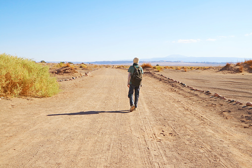 Traveler Walking on the Desert Road of Aldea de Tulor Archaeological Site in Atacama Desert, Northern Chile, South America