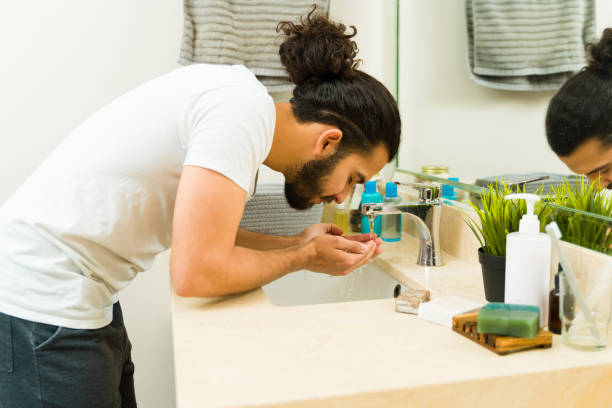 istock Fresh young man using soap to wash his face 1482615031