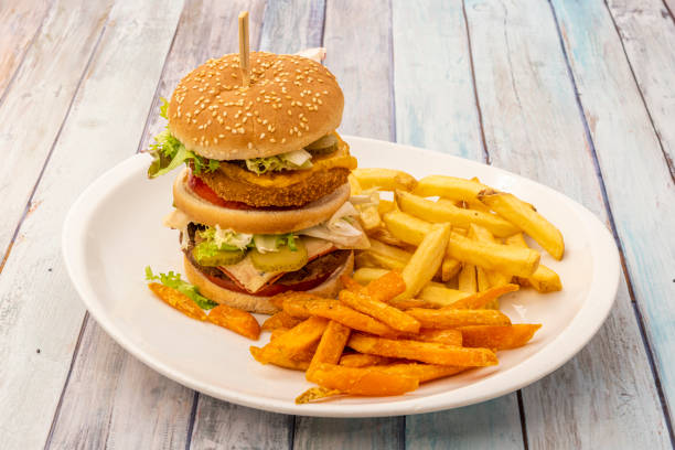 istock Spectacular double-decker burger with crispy beef and chicken, lettuce and pickles, mustard and tomato 1482615300