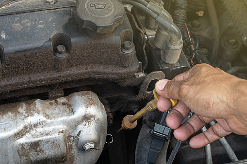 man check engine oil level before going on a trip or traveling. car inspection concept