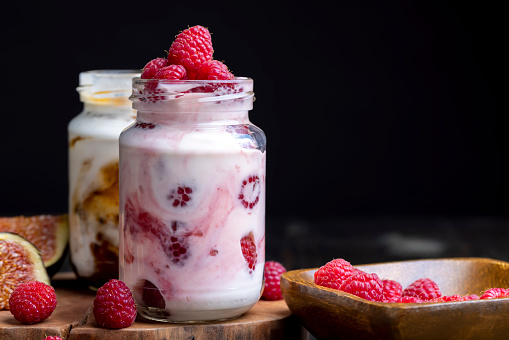 Milk yogurt with raspberries, layered yogurt with raspberry flavor and fresh berries