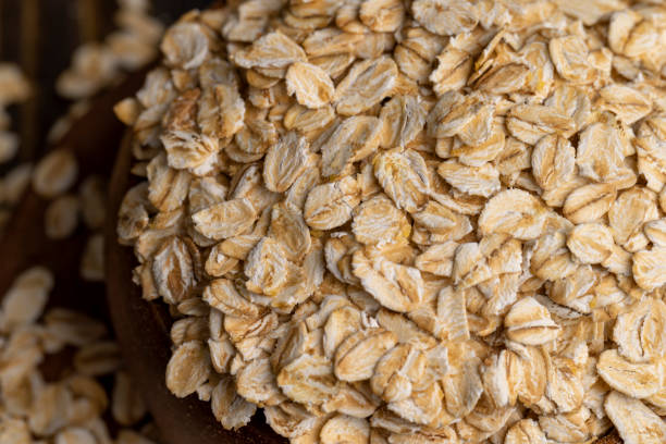 istock Oat flakes scattered on a wooden surface 1482619412