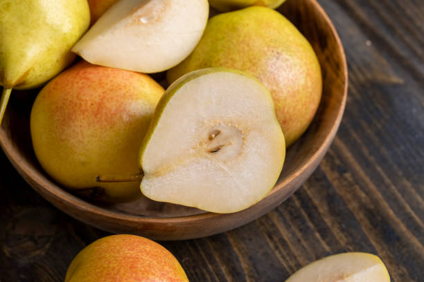 istock A yellow ripe pear with a red side on the table 1482619604