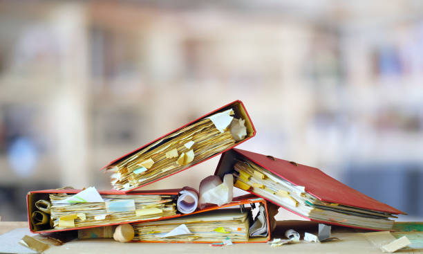 heap of messy file folders, red tape, bureaucracy, chaos, business concept, free copy space stock photo