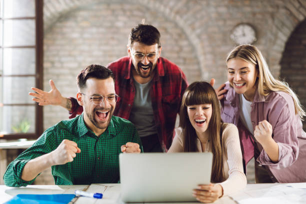 istock Cheerful  colleagues celebrating their business achievement in the office 1482624708