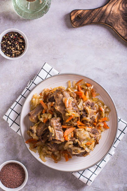 istock Stewed beef oxtail with wine and vegetables on a plate on the table top and vertical view 1482627518