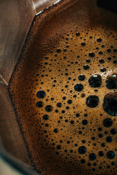 Above close shot of moka pot making espresso coffee on a stove