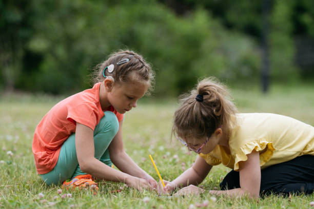 istock Two 8 years old girls drawing together in park. 1482630254
