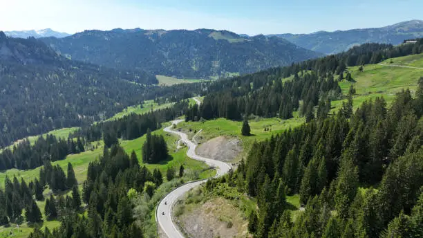 Drone shot of Riedberg pass with motorcyclist in Allgäu Alps