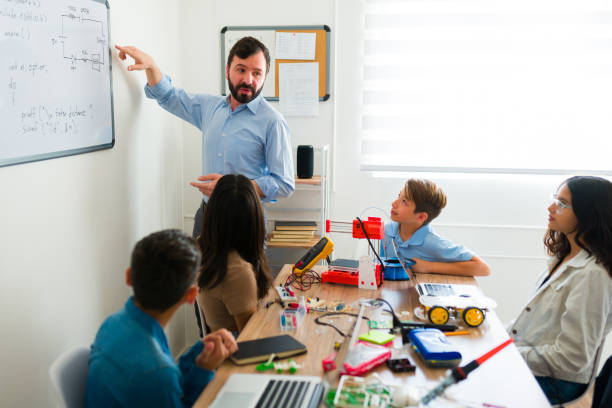 istock Handsome teacher giving an electronic or robotics course to teens 1482632954