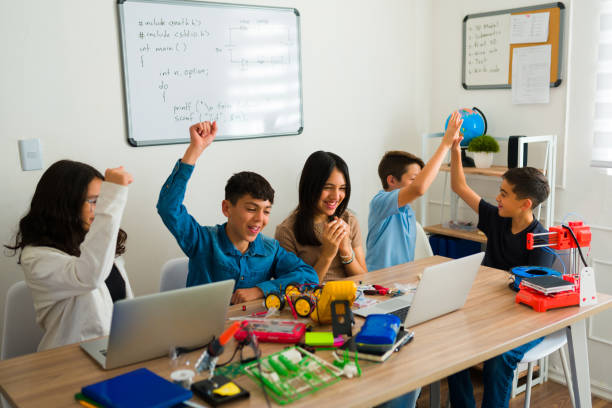 istock Cheerful young boy and girls enjoying their robotics course 1482634149