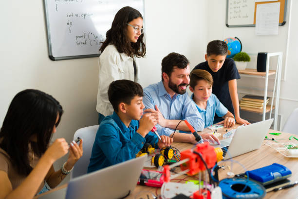 istock Robotics teacher teaching his teen students how to code 1482634241