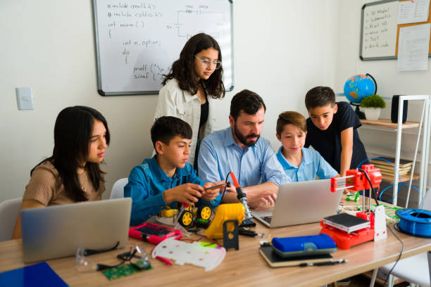 istock Young teen students coding with their robotics teacher 1482634258