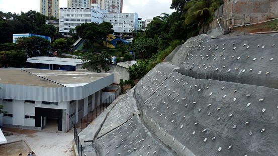 salvador, bahia, brazil - april 15, 2023: Concrete barrier to contain a hillside next to residences in the city of Salvador.