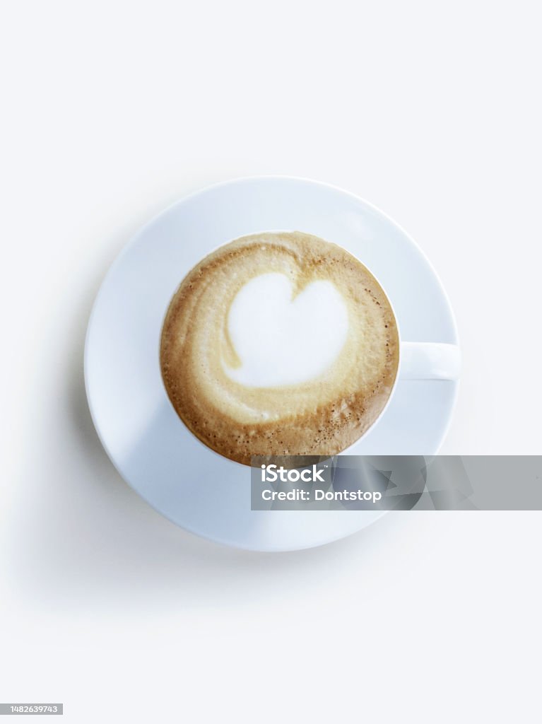 a sparkling cappuccino with a heart shape on it. on a white background. White Background Stock Photo