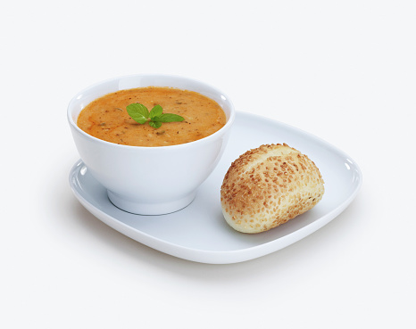 A bowl of soup and bread. On white background