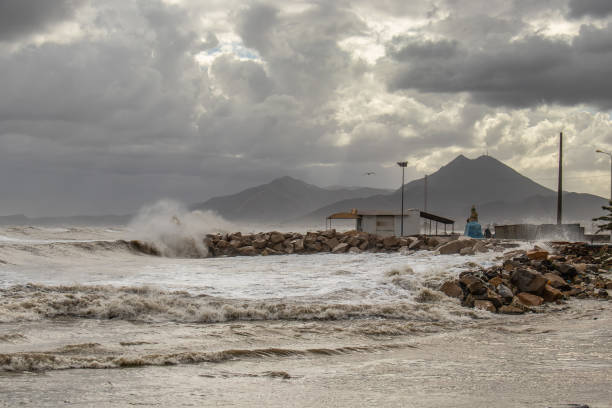 istock Powerful Waves Crashing Against Beach Breakwater During Stormy Weather 1482640683